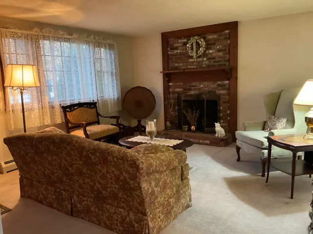 a living room with furniture a lamp and a fireplace