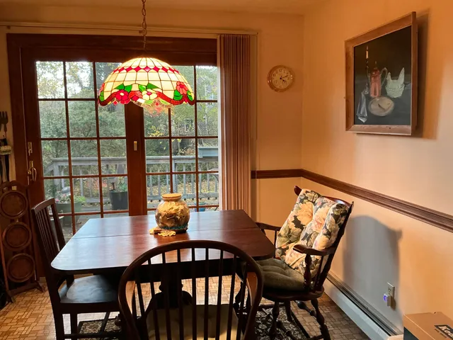 a view of a dining room with furniture wooden floor and chandelier