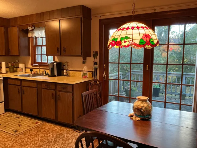 a kitchen with stainless steel appliances a sink cabinets and wooden floor