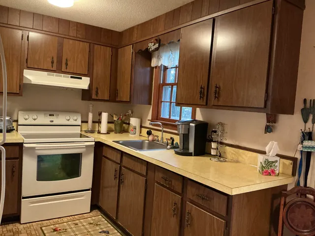 a kitchen with a sink cabinets and appliances