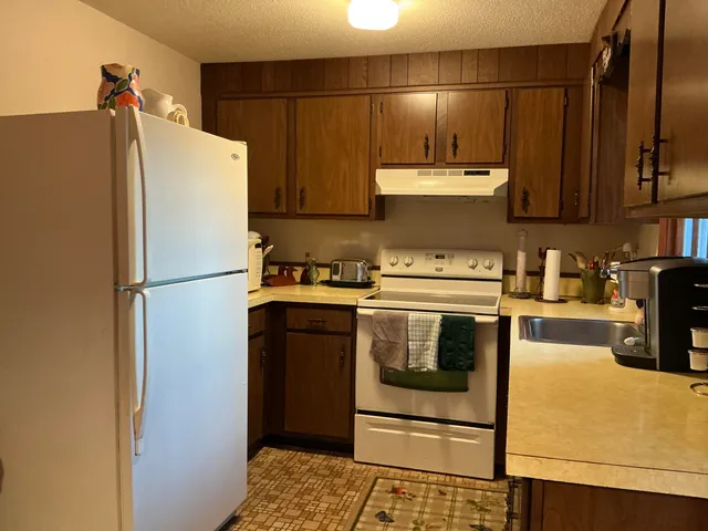 a kitchen with a refrigerator and a stove