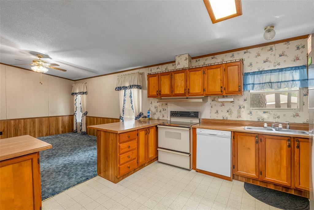 121 Woolworth Road Stonewall, LA 71078 - Photo 12 of 32 a kitchen with stainless steel appliances granite countertop a sink stove and cabinets