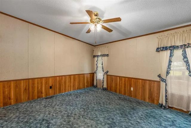 a view of empty room with ceiling fan