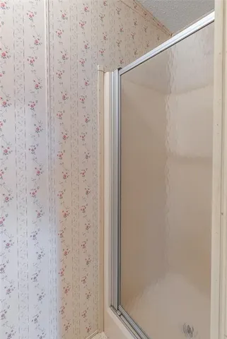 an empty room with chandelier fan