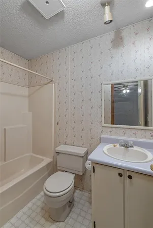 a view of a room with a ceiling fan
