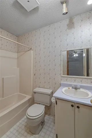 a view of a room with a ceiling fan