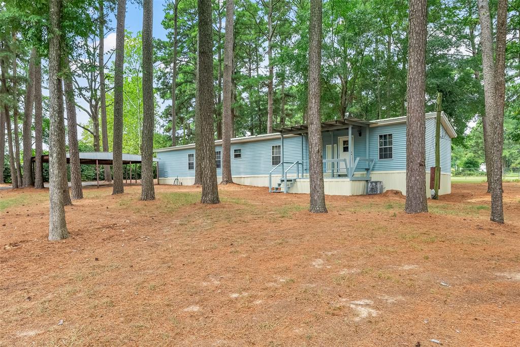 121 Woolworth Road Stonewall, LA 71078 - Photo 26 of 32 a view of a house with backyard and trees