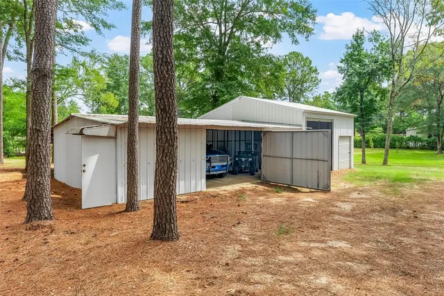 a view of a backyard with large trees