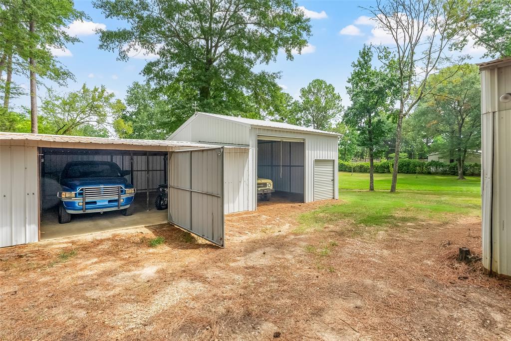 121 Woolworth Road Stonewall, LA 71078 - Photo 3 of 32 a view of a house with a yard and garage