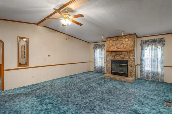 a view of empty room with fireplace