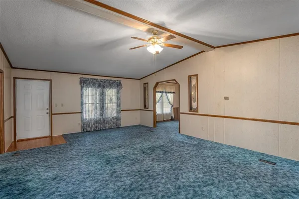 a view of a livingroom with an empty space and a window