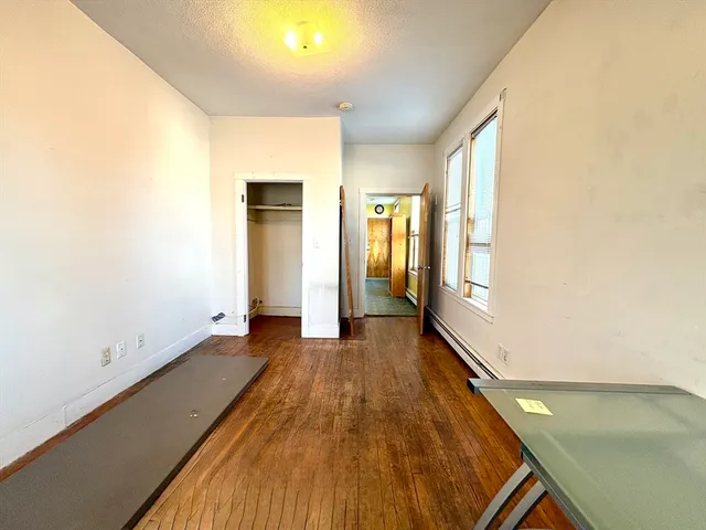 a view of a room with wooden floor and brick walls