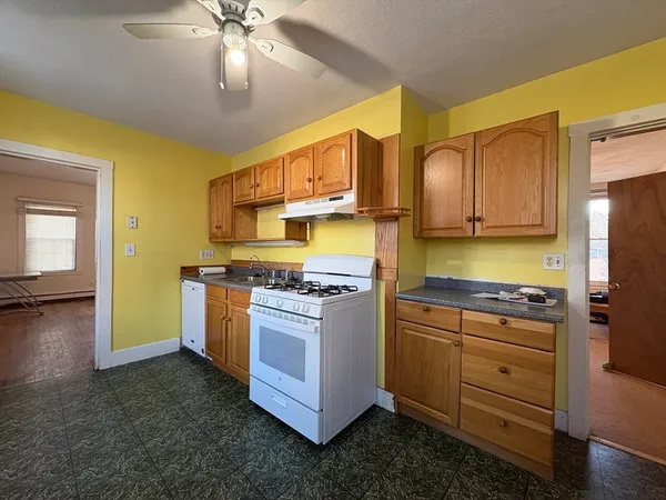a kitchen with stainless steel appliances granite countertop a stove a refrigerator and a sink with cabinets