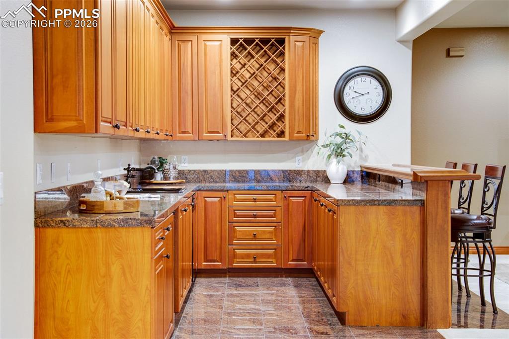 16075 Winding Trail Road Colorado Springs, CO 80908 - Photo 28 of 42 a kitchen with stainless steel appliances granite countertop a stove and a wooden floor