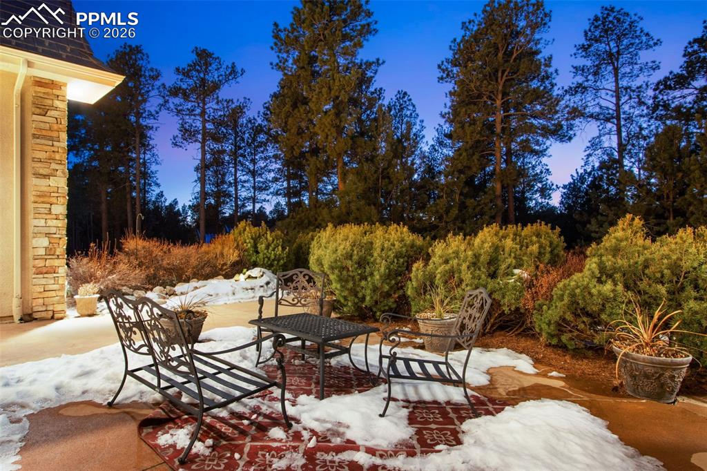 16075 Winding Trail Road Colorado Springs, CO 80908 - Photo 5 of 42 a view of a chairs and table in backyard