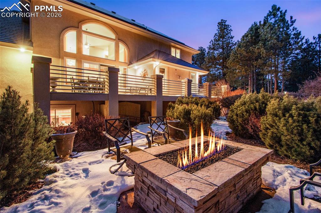 16075 Winding Trail Road Colorado Springs, CO 80908 - Photo 7 of 42 a view of a dinning tables and chairs in patio
