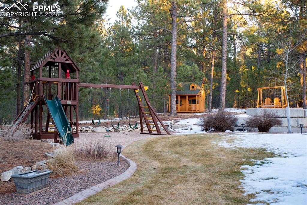 16075 Winding Trail Road Colorado Springs, CO 80908 - Photo 8 of 42 a view of a house with backyard water fountain and a slide