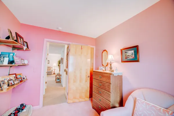a bedroom with a bed and a painting on the wall