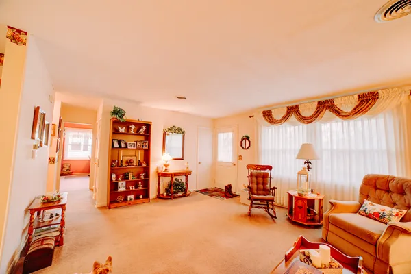a bedroom with furniture and a rug