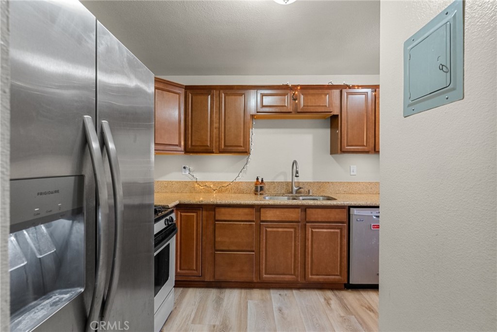 31363 The Old Road, Unit A Castaic, CA 91384 - Photo 19 of 43 a kitchen with stainless steel appliances granite countertop a sink a stove and refrigerator