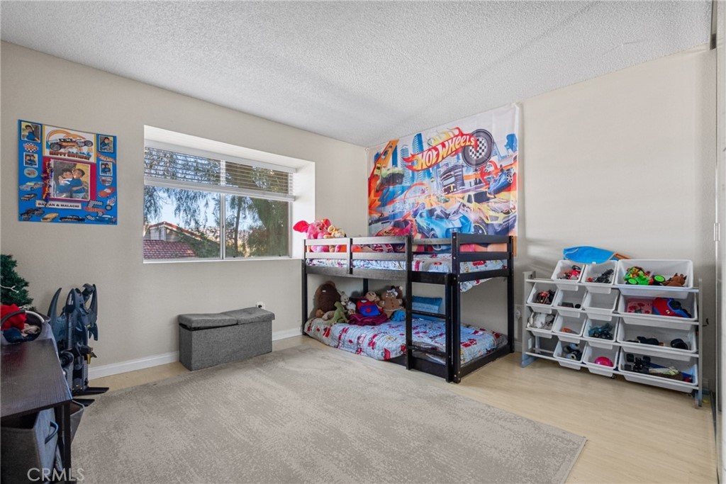 31363 The Old Road, Unit A Castaic, CA 91384 - Photo 23 of 43 a bedroom with furniture a baby crib and a couch