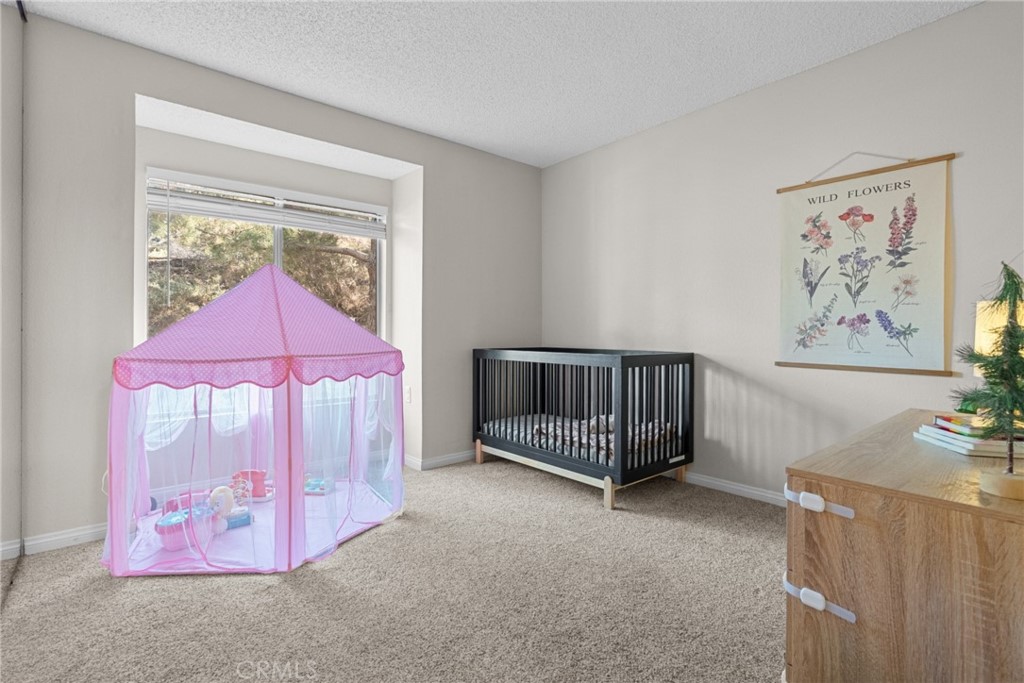 31363 The Old Road, Unit A Castaic, CA 91384 - Photo 25 of 43 a bed room with a bed and a painting on the wall