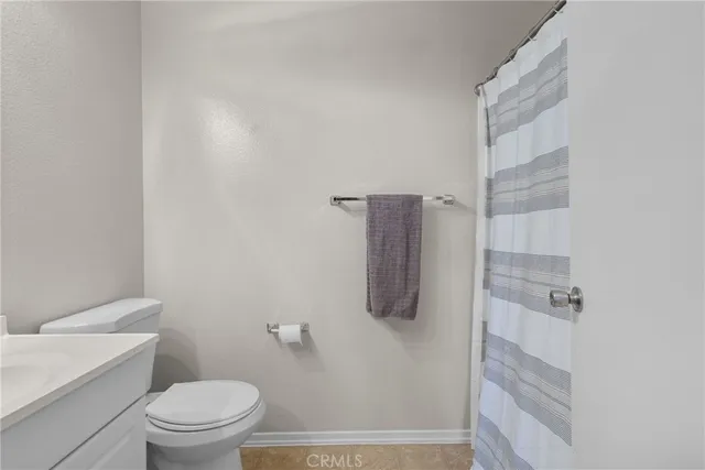 a bathroom with a shower toilet and sink