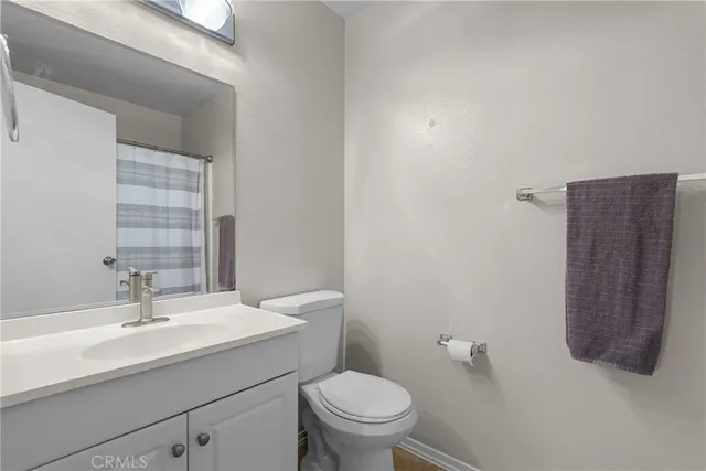 a bathroom with a sink a toilet and mirror