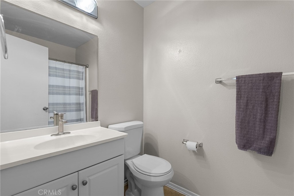 31363 The Old Road, Unit A Castaic, CA 91384 - Photo 28 of 43 a bathroom with a sink a toilet and mirror