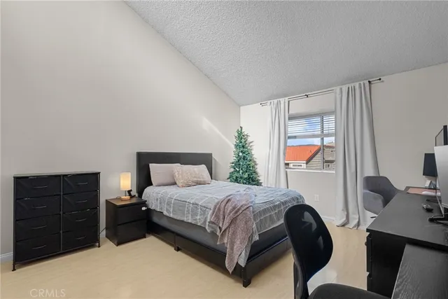 a bedroom with a bed window and a table