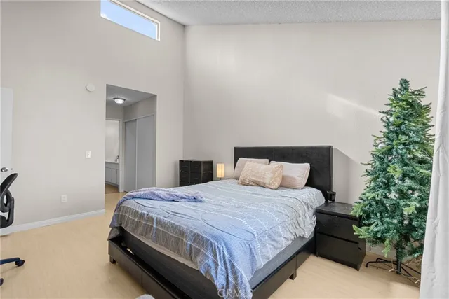 a bedroom with a bed and a potted plant