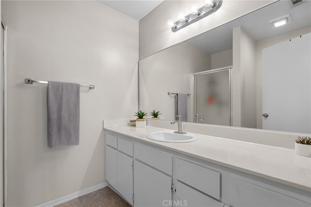 31363 The Old Road, Unit A Castaic, CA 91384 - Photo 35 of 43 a bathroom with a double vanity sink and a mirror
