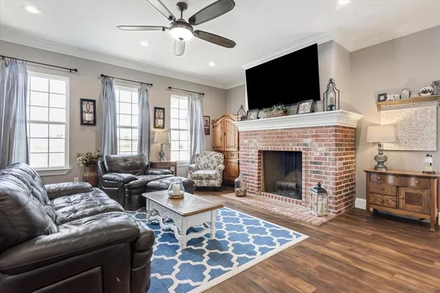 a living room with furniture fireplace and flat screen tv