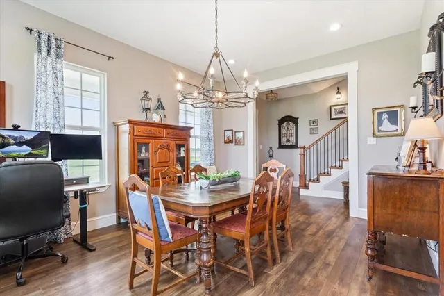 a view of a dining room with furniture and a chandelier