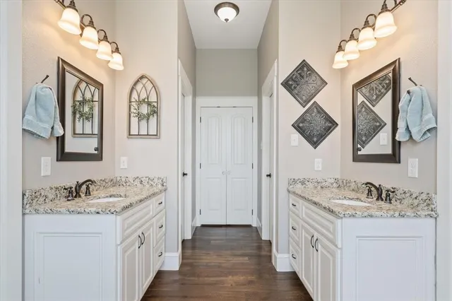 a spacious bathroom with a granite countertop sink mirror and vanity