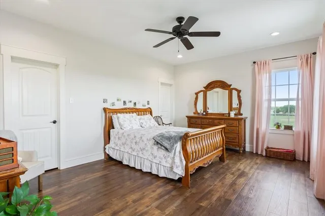 a bedroom with a bed and a large window