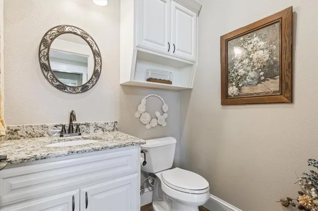 a bathroom with a toilet a sink and a mirror