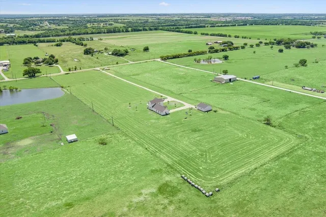 a view of a field with an ocean