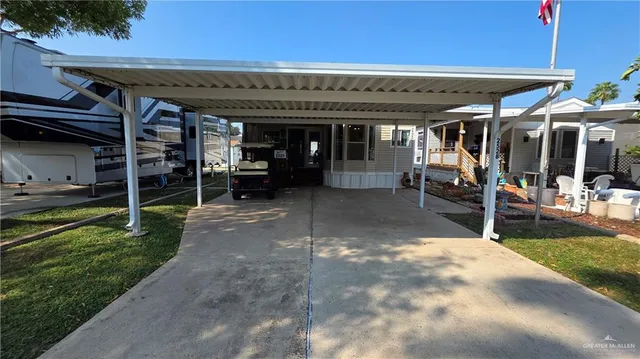 a view of a patio with table and chairs under an umbrella