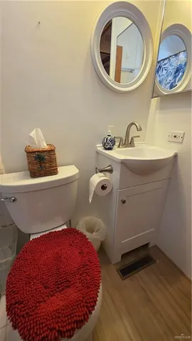 a bathroom with a toilet sink and mirror