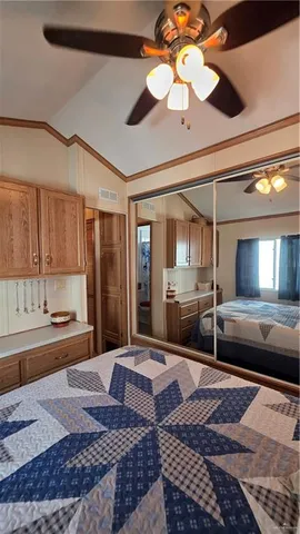 a bedroom with a large bed and a chandelier