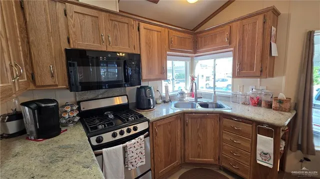 a kitchen with a stove a sink and a microwave