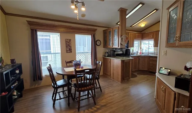 a kitchen with granite countertop a table chairs stove and cabinets