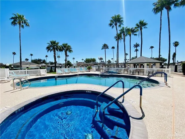 a view of swimming pool with a table and chairs