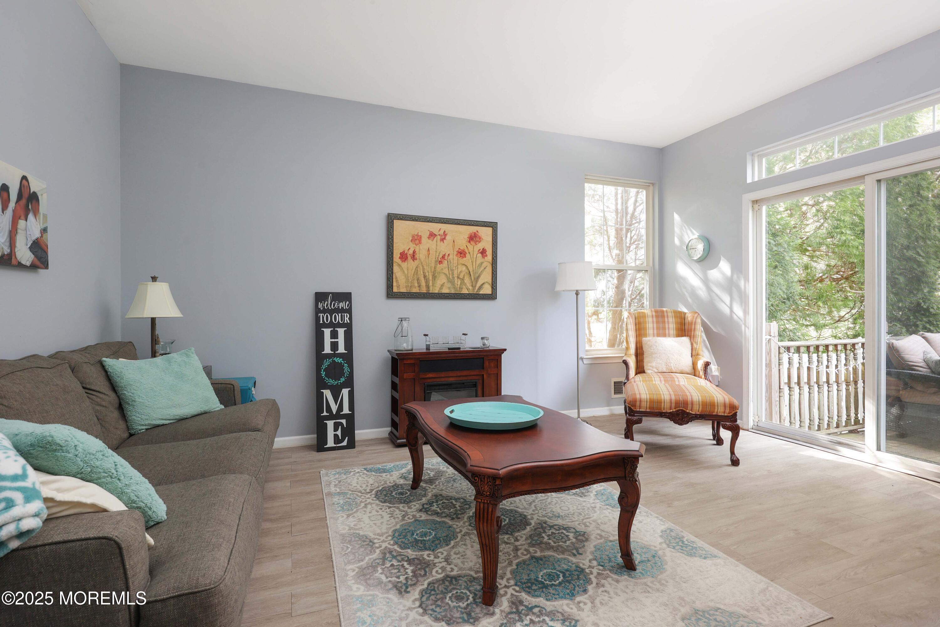 1 Exeter Pass Colts Neck, NJ 07722 - Photo 11 of 42 a living room with furniture a table and a large window