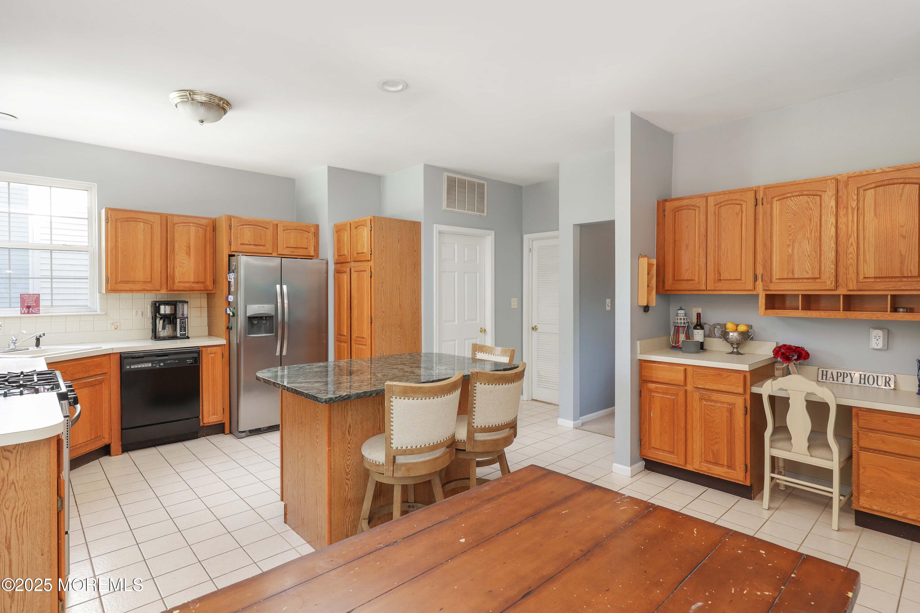 1 Exeter Pass Colts Neck, NJ 07722 - Photo 14 of 42 a kitchen with stainless steel appliances a stove a sink dishwasher a refrigerator and cabinets with wooden floor