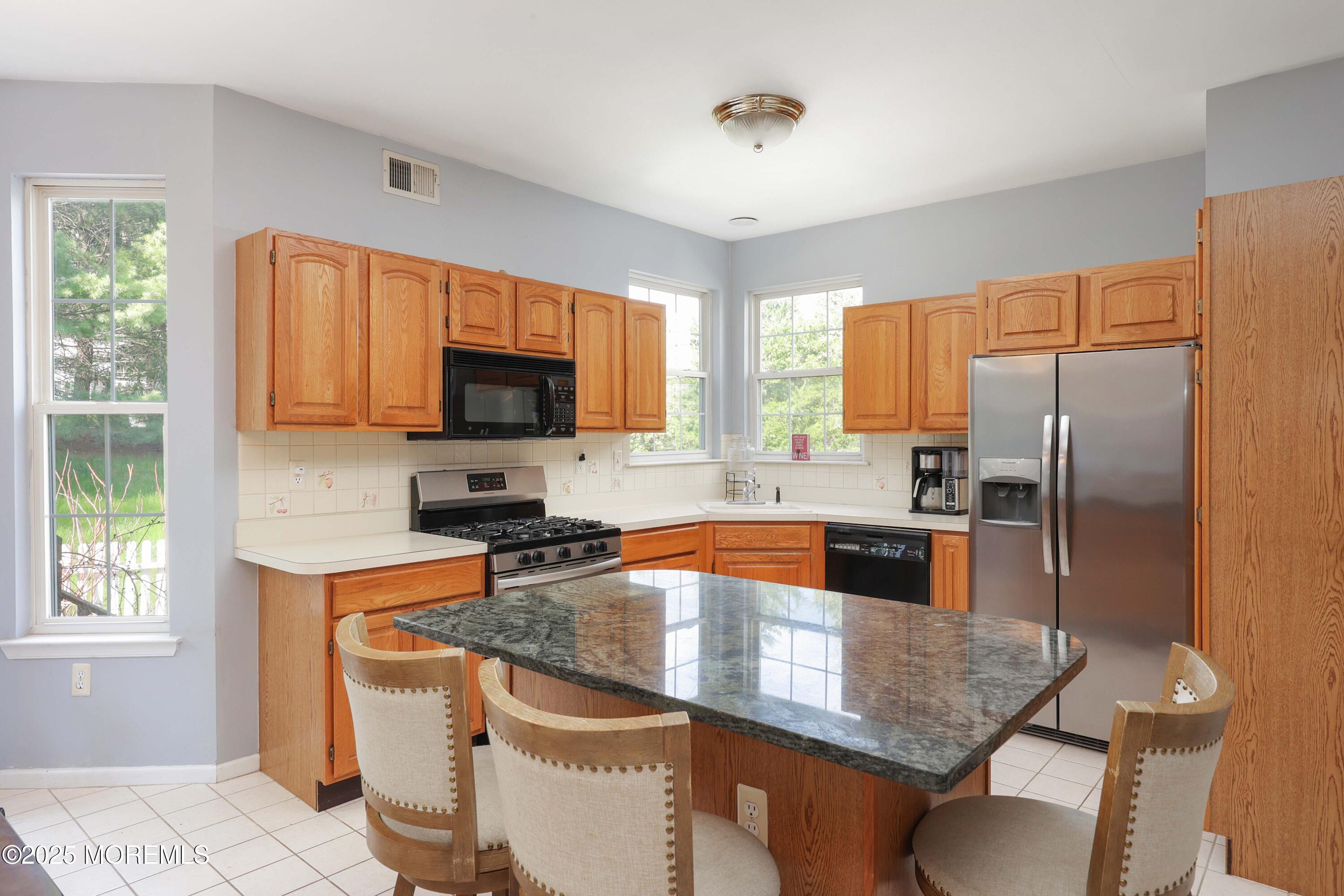 1 Exeter Pass Colts Neck, NJ 07722 - Photo 15 of 42 a kitchen with stainless steel appliances granite countertop a sink a stove and a refrigerator