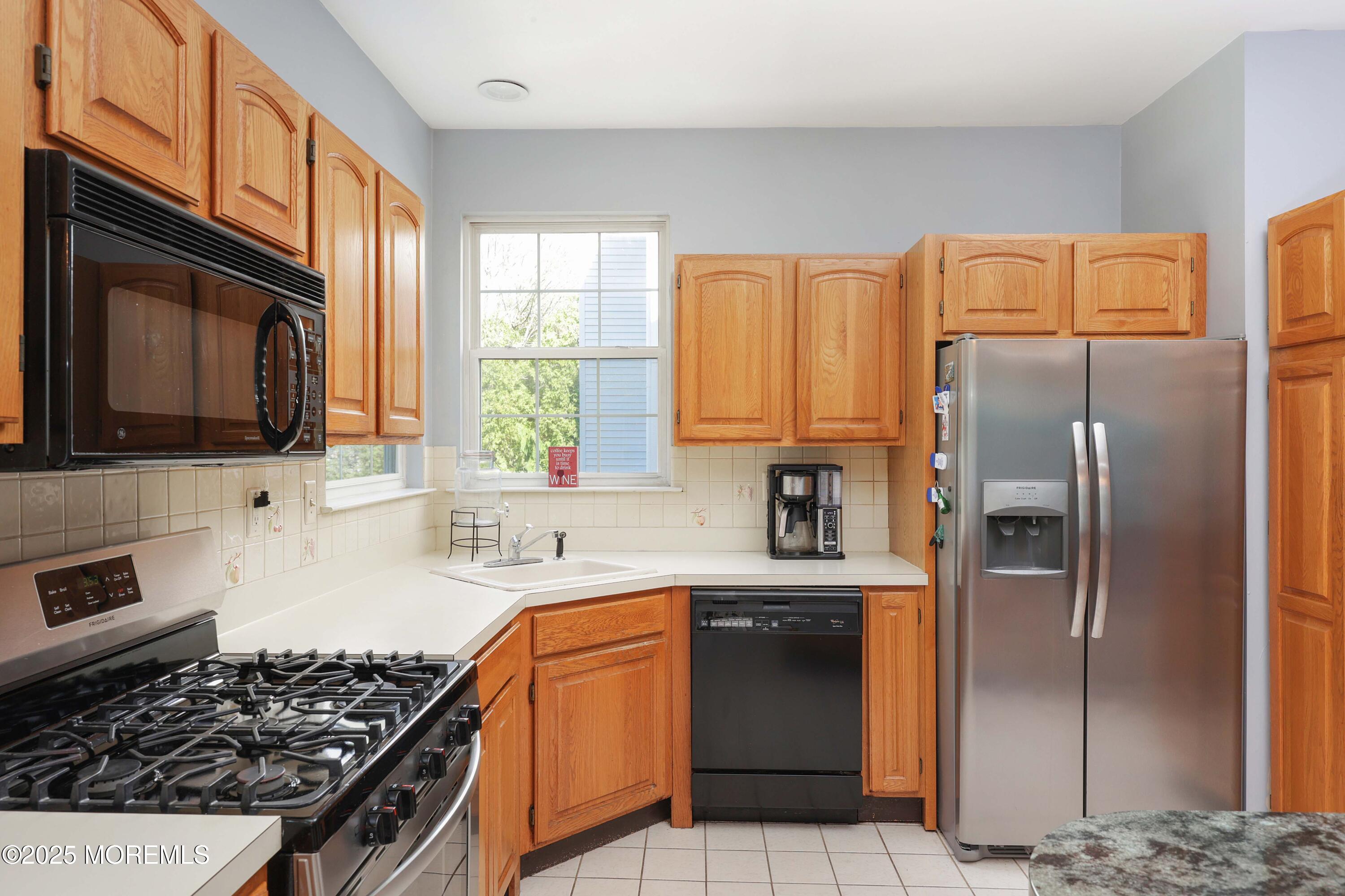 1 Exeter Pass Colts Neck, NJ 07722 - Photo 17 of 42 a kitchen with stainless steel appliances granite countertop a refrigerator stove top oven a sink and dishwasher