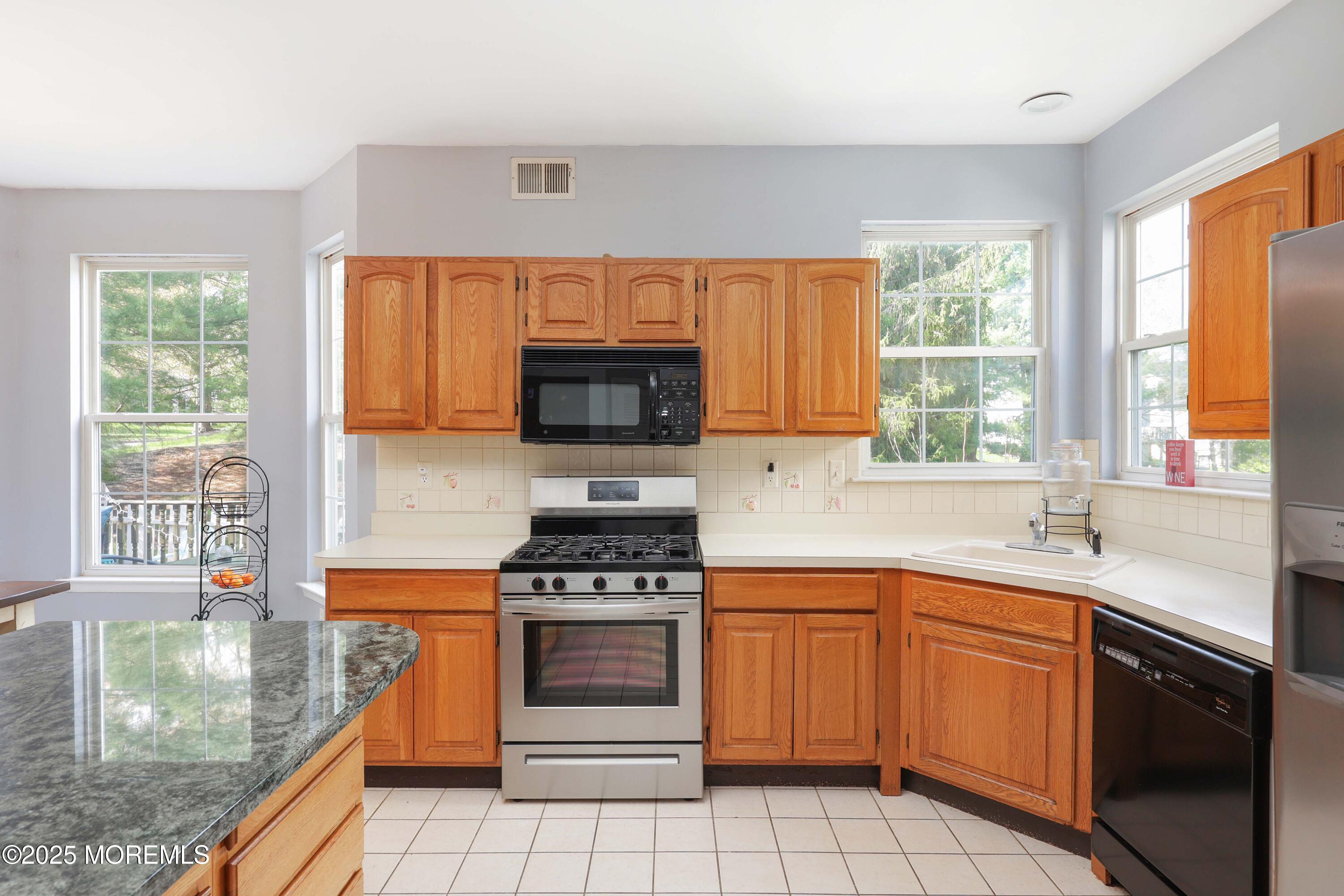 1 Exeter Pass Colts Neck, NJ 07722 - Photo 18 of 42 a kitchen with a sink stove top oven and cabinets