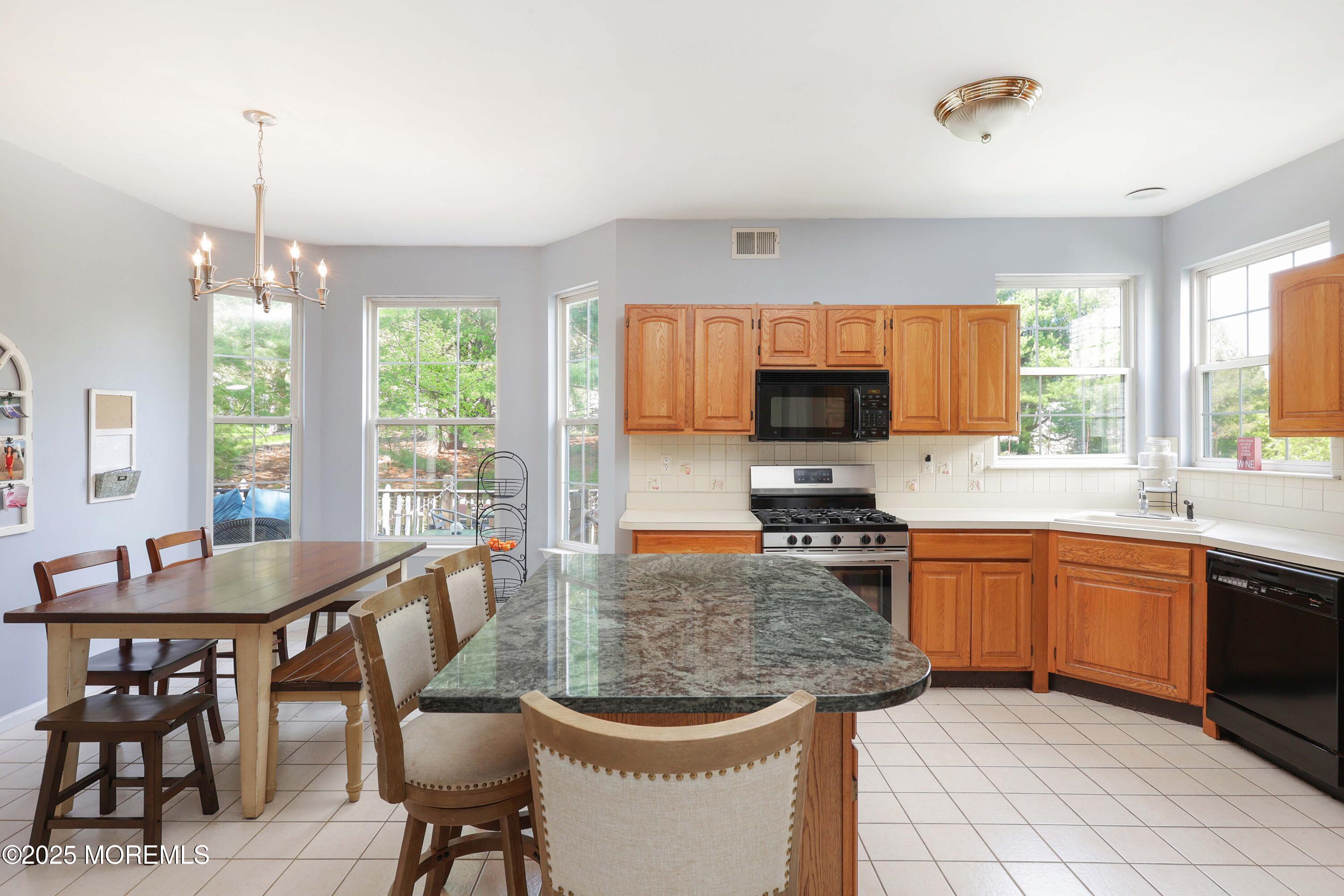 1 Exeter Pass Colts Neck, NJ 07722 - Photo 19 of 42 a kitchen with a stove a sink and a refrigerator
